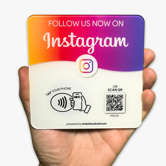 A square plaque with a gradient from orange to purple, featuring the Instagram logo and text "Follow Us Now on Instagram." It offers options to "Tap Your Phone" using NFC or "Scan QR" code, held in a person's hand
